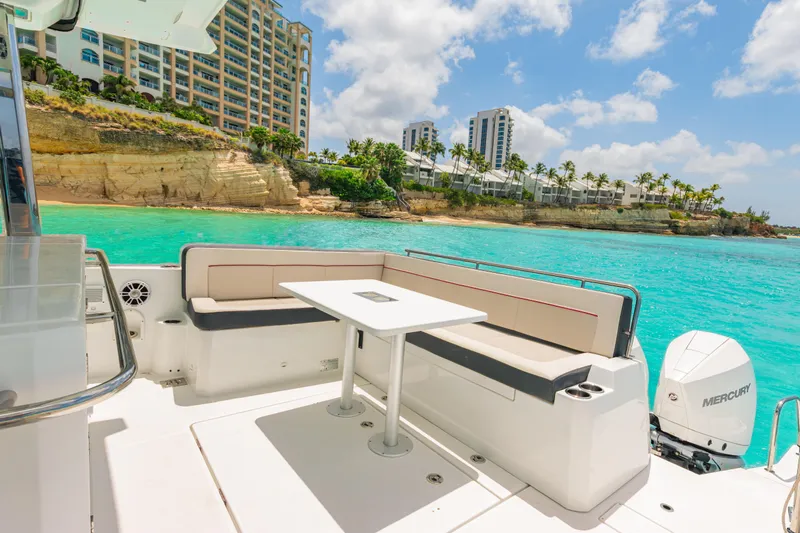  Yacht Photos Pics 2025 Jeanneau Cap Camarat 12.5 WA boat with scenic coastal view and turquoise waters.