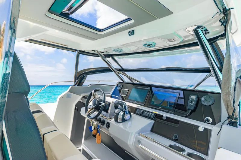  Yacht Photos Pics Interior of 2025 Jeanneau Cap Camarat 12.5 WA boat with modern dashboard and ocean view.
