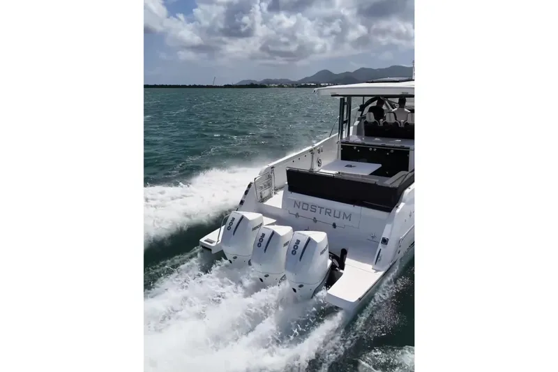  Yacht Photos Pics 2025 Jeanneau Cap Camarat 12.5 WA cruising on open water with triple outboard engines.