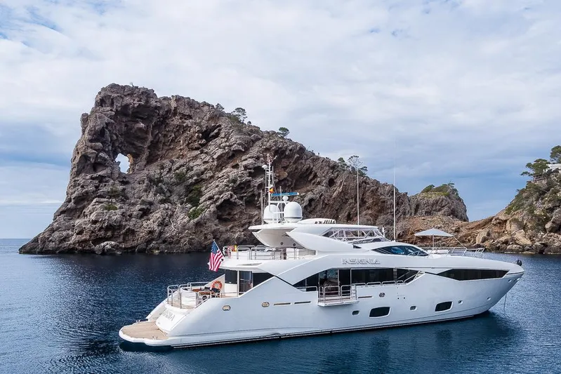 Insignia Yacht Photos Pics Luxury Sunseeker 115 yacht cruising near rocky island, 2015 model.