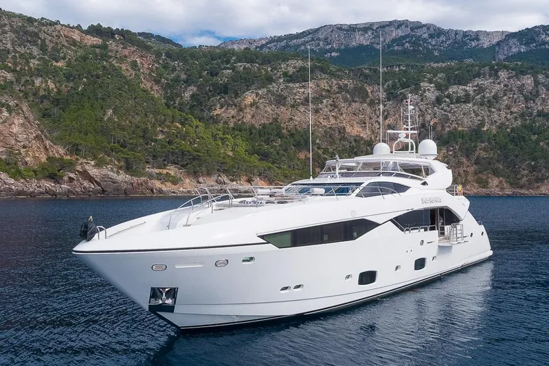 Insignia Yacht Photos Pics Luxurious 2015 Sunseeker 115 yacht cruising near scenic rocky coastline.