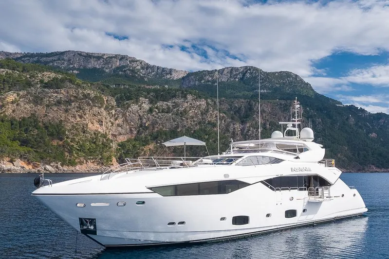 Insignia Yacht Photos Pics Luxurious 2015 Sunseeker 115 yacht cruising near scenic rocky coastline.