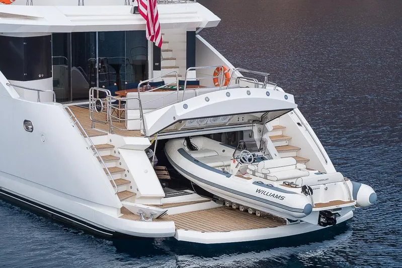 Insignia Yacht Photos Pics Luxury Sunseeker 115 yacht with tender boat, 2015 model, docked on calm water.