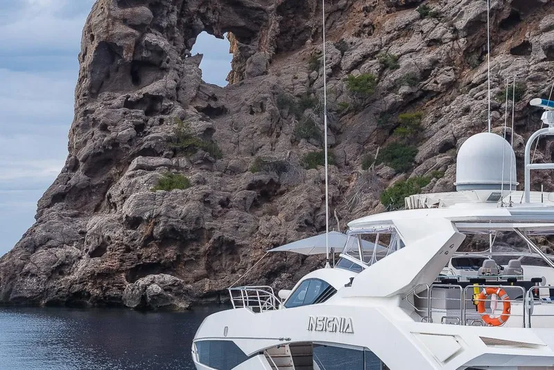 Insignia Yacht Photos Pics Luxury Sunseeker 115 yacht near rocky coastal cliffs, 2015 model.