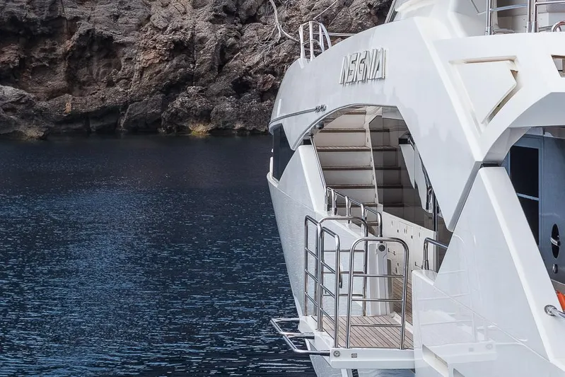 Insignia Yacht Photos Pics Luxury Sunseeker 115 yacht from 2015 docked by rocky shoreline.