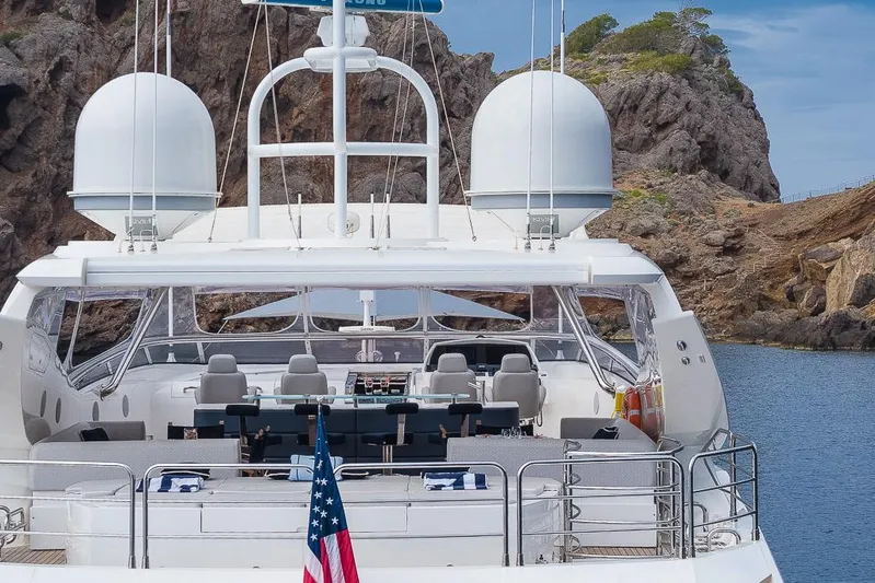 Insignia Yacht Photos Pics Luxury Sunseeker 115 yacht, 2015 model, docked near rocky coastline.