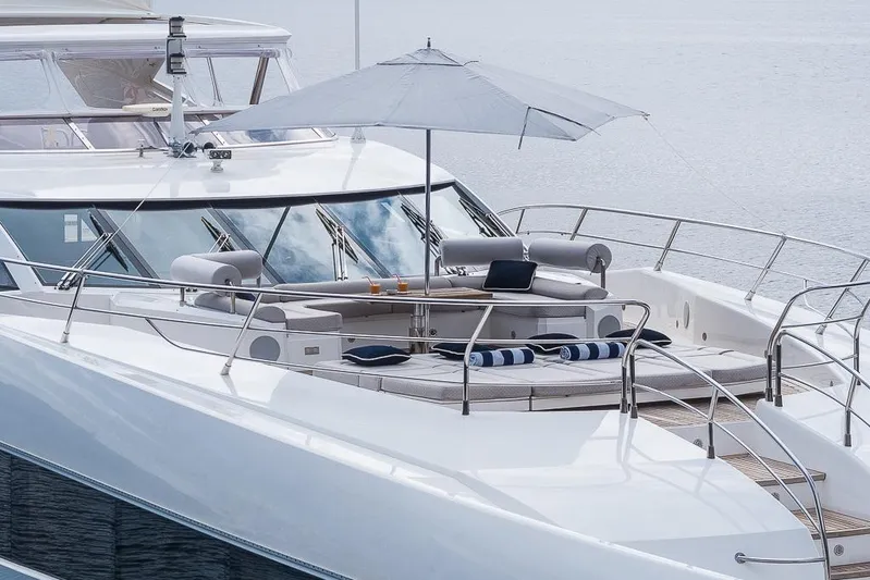 Insignia Yacht Photos Pics Luxurious 2015 Sunseeker 115 yacht deck with seating, umbrella, and ocean view.
