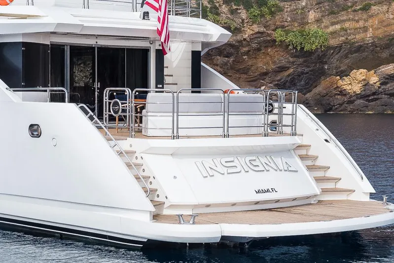Insignia Yacht Photos Pics Luxury Sunseeker 115 yacht, 2015 model, docked by rocky shoreline.