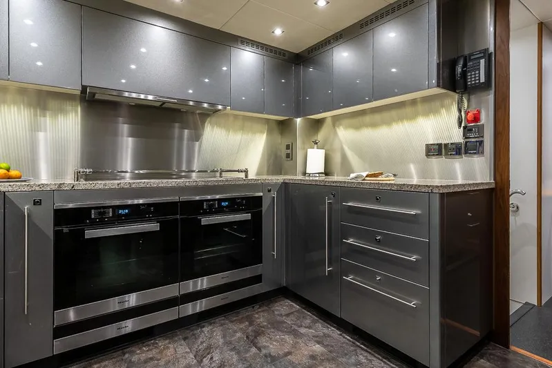 Insignia Yacht Photos Pics Modern kitchen interior on a 2015 Sunseeker 115 yacht, featuring sleek cabinetry and appliances.