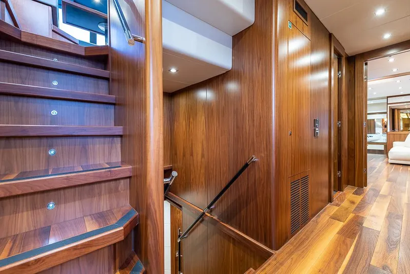 Insignia Yacht Photos Pics Luxurious wooden interior of 2015 Sunseeker 115 yacht, featuring elegant stairs and hallway.