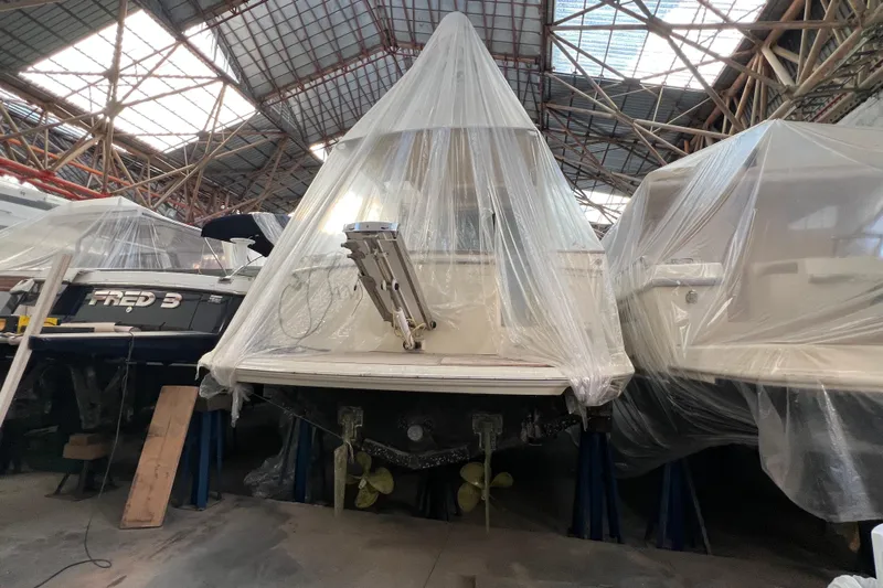  Yacht Photos Pics 2009 Cantieri Estensi Goldstar 42 Fly yacht covered in plastic, stored indoors.