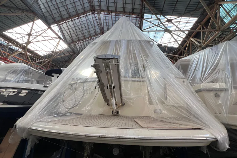  Yacht Photos Pics 2009 Cantieri Estensi Goldstar 42 Fly yacht covered in protective plastic in a warehouse.