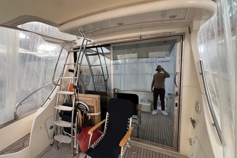  Yacht Photos Pics 2009 Cantieri Estensi Goldstar 42 Fly yacht interior with ladder and seating area.