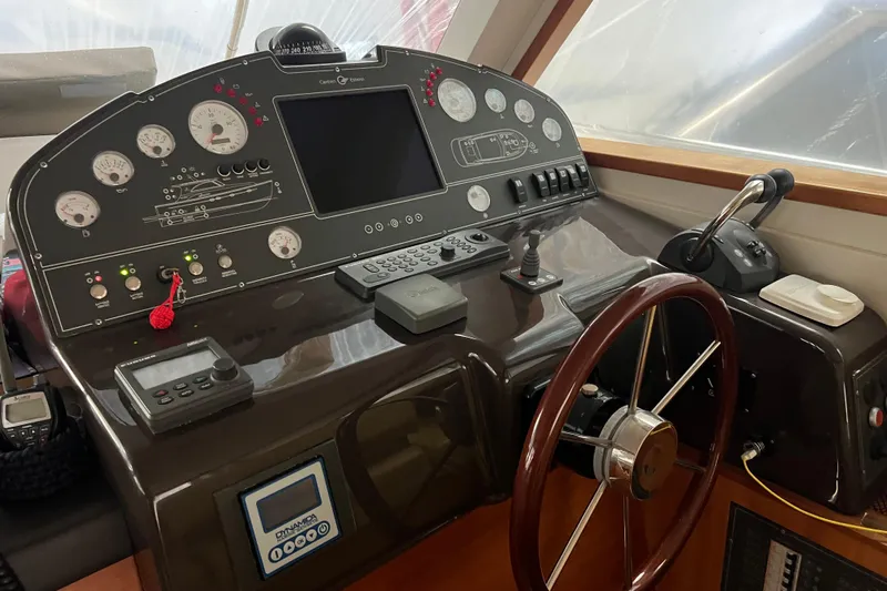  Yacht Photos Pics Control panel of 2009 Cantieri Estensi Goldstar 42 Fly yacht with steering wheel and navigation instruments.