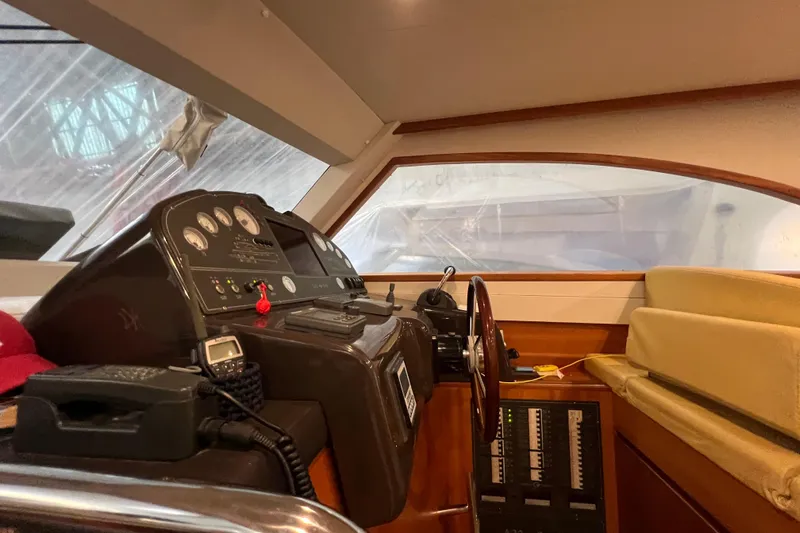  Yacht Photos Pics Interior helm of 2009 Cantieri Estensi Goldstar 42 Fly yacht, featuring control panel and seating.