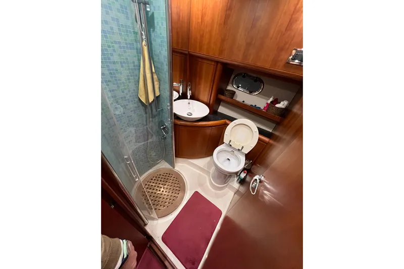  Yacht Photos Pics Luxurious 2009 Cantieri Estensi Goldstar 42 Fly yacht bathroom with shower and wooden accents.