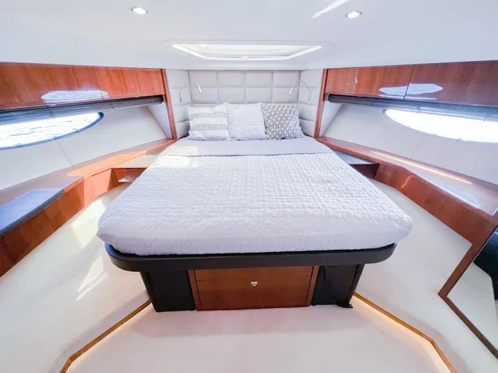  Yacht Photos Pics Luxurious cabin interior of 2013 Princess 60 yacht with elegant bedding and wood accents.