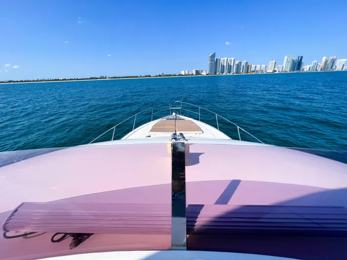  Yacht Photos Pics Princess 60 yacht cruising on blue ocean with city skyline in background, 2013 model.