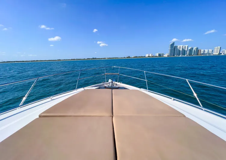  Yacht Photos Pics Princess 60 yacht cruising on blue ocean with city skyline in background, 2013 model.