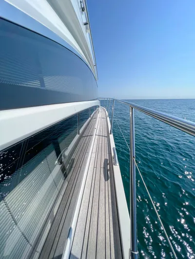  Yacht Photos Pics Side view of 2013 Princess 60 yacht on open sea under clear blue sky.