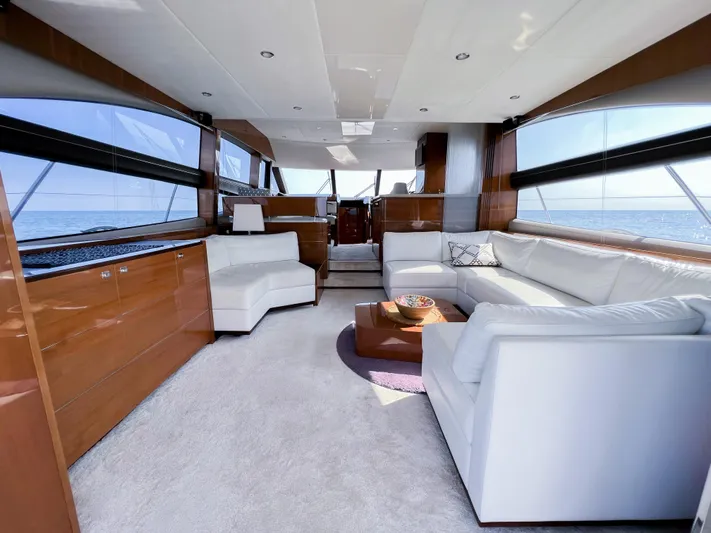  Yacht Photos Pics Luxurious interior of 2013 Princess 60 yacht with white sofas and panoramic windows.