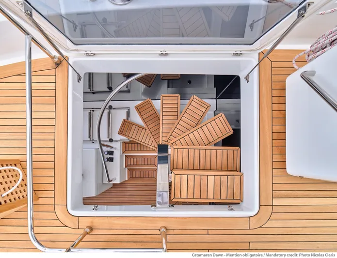 Dawn Yacht Photos Pics Elegant wooden staircase on 2019 Sunreef 60 yacht, showcasing luxurious nautical design.