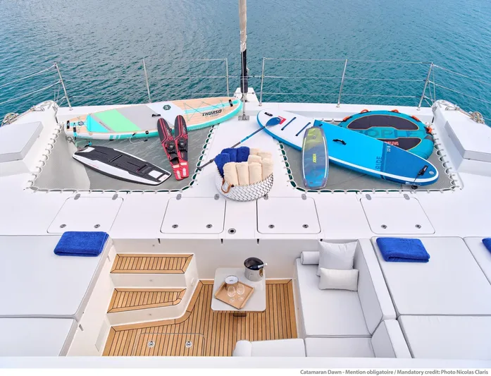 Dawn Yacht Photos Pics Luxurious 2019 Sunreef 60 yacht deck with paddleboards and lounging area.