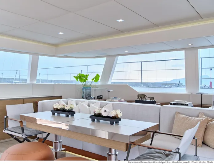 Dawn Yacht Photos Pics Luxurious Sunreef 60 catamaran interior, 2019 model, featuring elegant seating and modern decor.