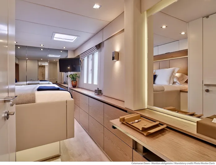 Dawn Yacht Photos Pics Luxurious interior of 2019 Sunreef 60 catamaran, featuring elegant bedroom and modern amenities.