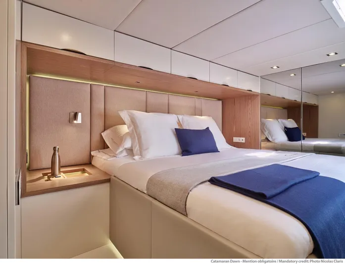 Dawn Yacht Photos Pics Luxurious Sunreef 60 yacht bedroom interior, 2019 model, featuring elegant bedding and modern design.