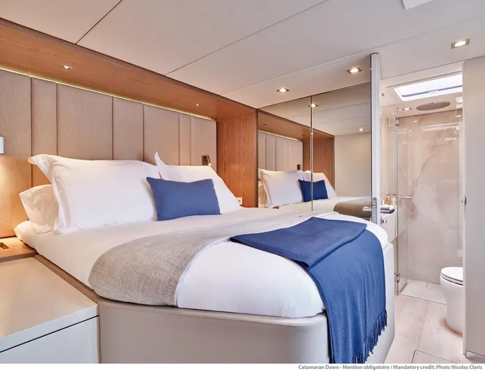 Dawn Yacht Photos Pics Luxurious Sunreef 60 yacht bedroom interior, 2019 model, featuring elegant bedding and modern design.