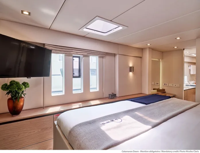 Dawn Yacht Photos Pics Luxurious interior of 2019 Sunreef 60 catamaran with modern decor and large windows.