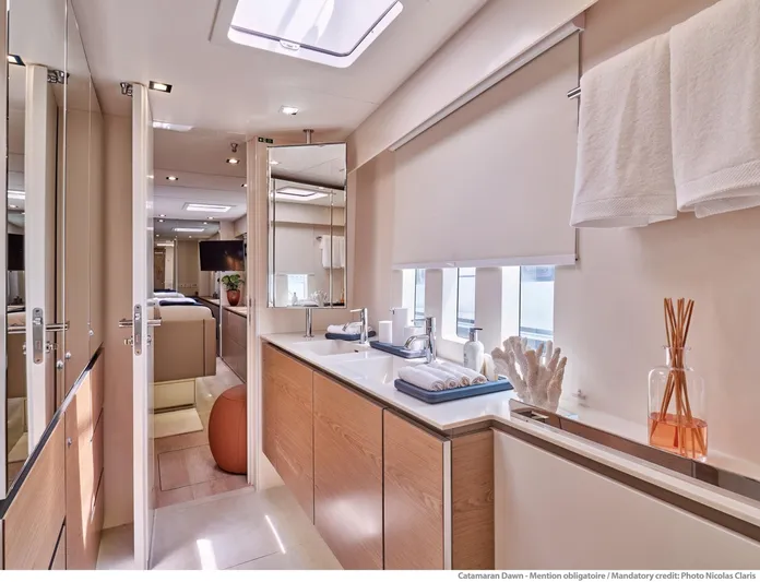 Dawn Yacht Photos Pics Luxurious interior of 2019 Sunreef 60 catamaran, featuring modern bathroom with elegant fixtures.