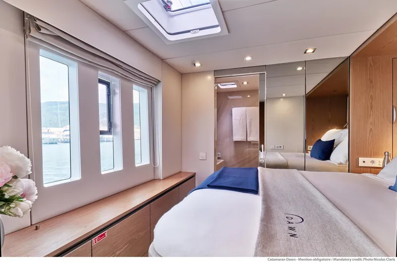 Dawn Yacht Photos Pics Luxurious Sunreef 60 yacht bedroom interior, featuring modern design and large windows, 2019 model.
