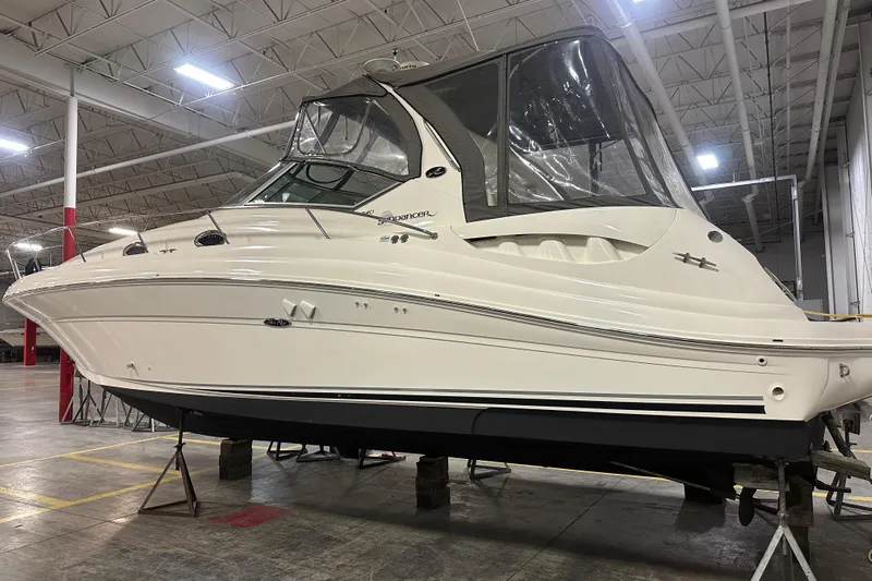  Yacht Photos Pics 2004 Sea Ray 340 Sundancer boat in indoor storage, elevated on stands.