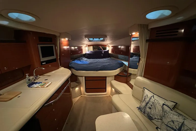  Yacht Photos Pics Luxurious interior of 2004 Sea Ray 340 Sundancer yacht with cozy bed and kitchenette.