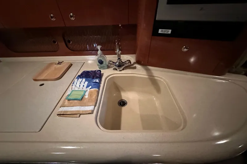  Yacht Photos Pics 2004 Sea Ray 340 Sundancer kitchen sink with countertop, faucet, and towels.