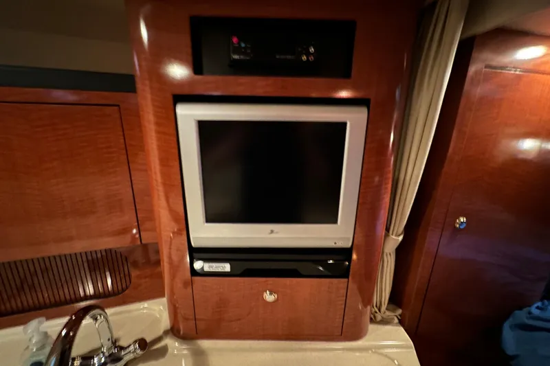  Yacht Photos Pics Interior of 2004 Sea Ray 340 Sundancer with built-in TV and wood paneling.