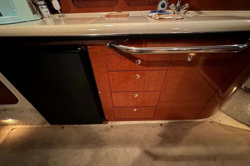  Yacht Photos Pics 2004 Sea Ray 340 Sundancer interior kitchen with wood cabinetry and countertop.