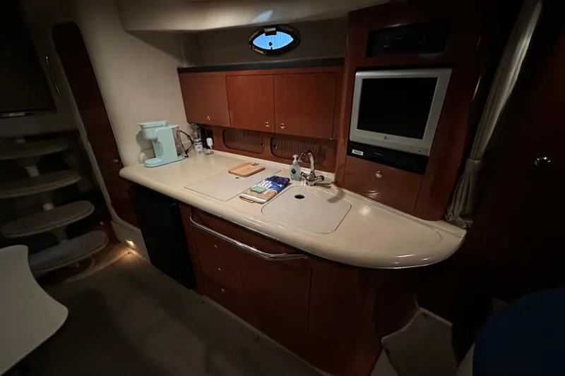  Yacht Photos Pics 2004 Sea Ray 340 Sundancer interior with kitchenette, sink, and TV.