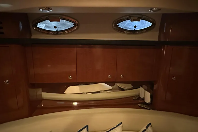  Yacht Photos Pics Interior of 2004 Sea Ray 340 Sundancer with wooden cabinets and porthole windows.