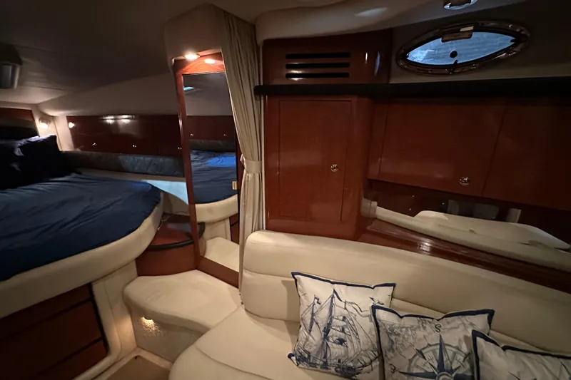  Yacht Photos Pics Luxurious interior of 2004 Sea Ray 340 Sundancer with cozy seating and nautical-themed pillows.