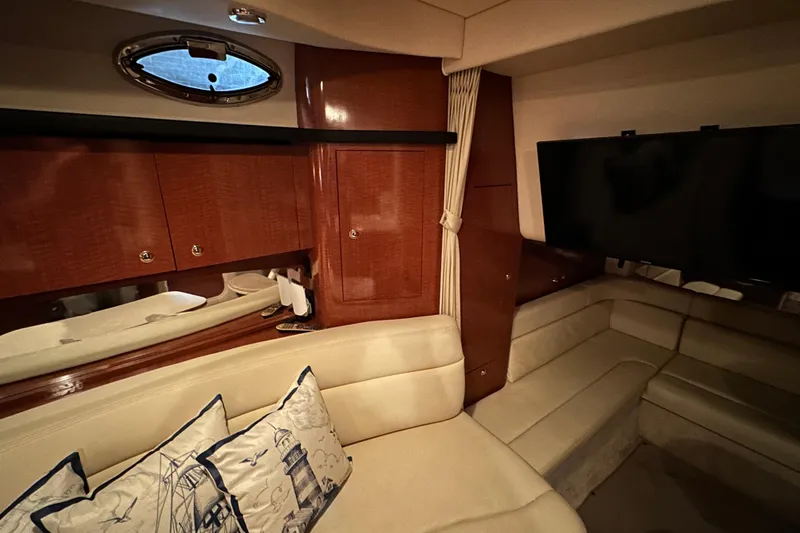  Yacht Photos Pics Luxurious interior of 2004 Sea Ray 340 Sundancer yacht with plush seating and elegant wood finishes.