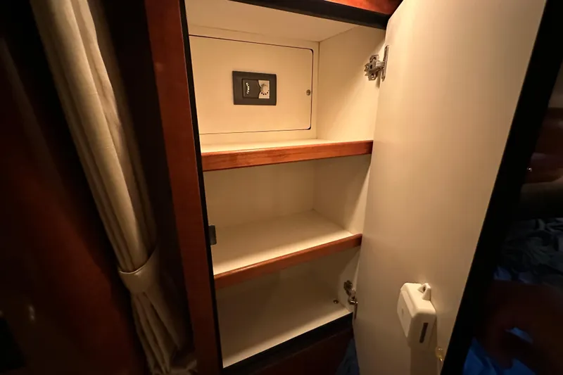  Yacht Photos Pics Open cabinet with shelves inside a 2004 Sea Ray 340 Sundancer boat.
