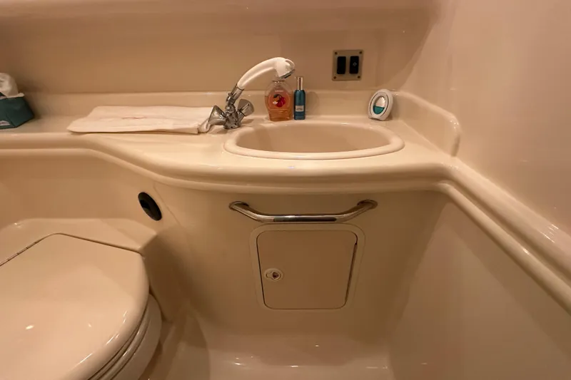  Yacht Photos Pics Bathroom interior of 2004 Sea Ray 340 Sundancer yacht, featuring sink and toilet.