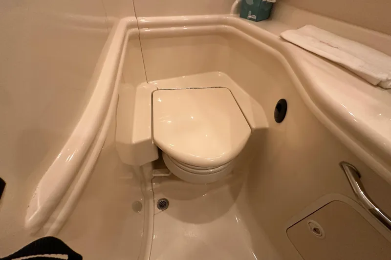  Yacht Photos Pics Compact bathroom in 2004 Sea Ray 340 Sundancer yacht, featuring a marine toilet.