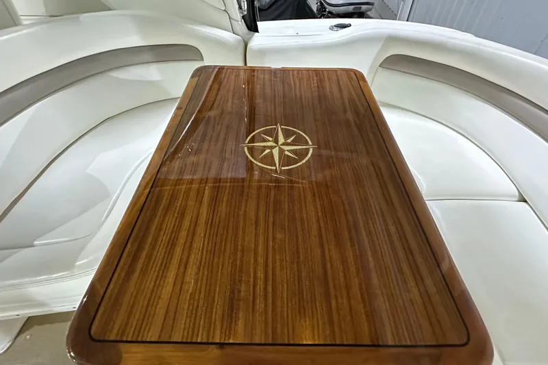  Yacht Photos Pics Luxurious wooden table with compass design on 2004 Sea Ray 340 Sundancer boat.