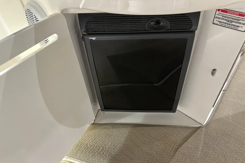  Yacht Photos Pics Mini fridge inside 2004 Sea Ray 340 Sundancer boat, with open cabinet door.