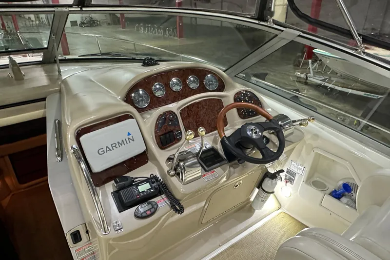  Yacht Photos Pics 2004 Sea Ray 340 Sundancer helm with Garmin navigation, wood accents, and steering wheel.