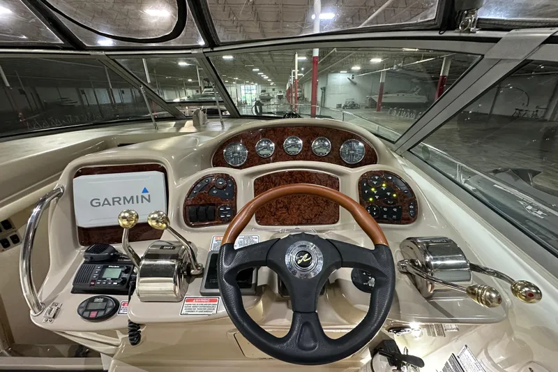  Yacht Photos Pics 2004 Sea Ray 340 Sundancer helm with Garmin navigation and wood-accented dashboard.